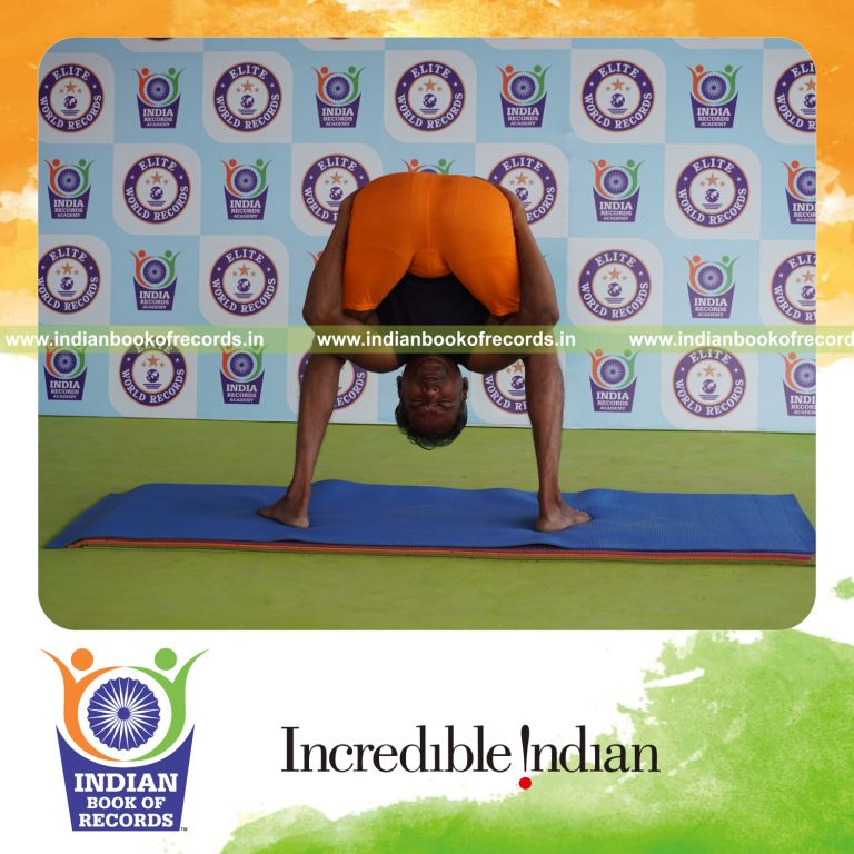 individual holding uthitha titibasana yoga pose for record in Indian Book of Records