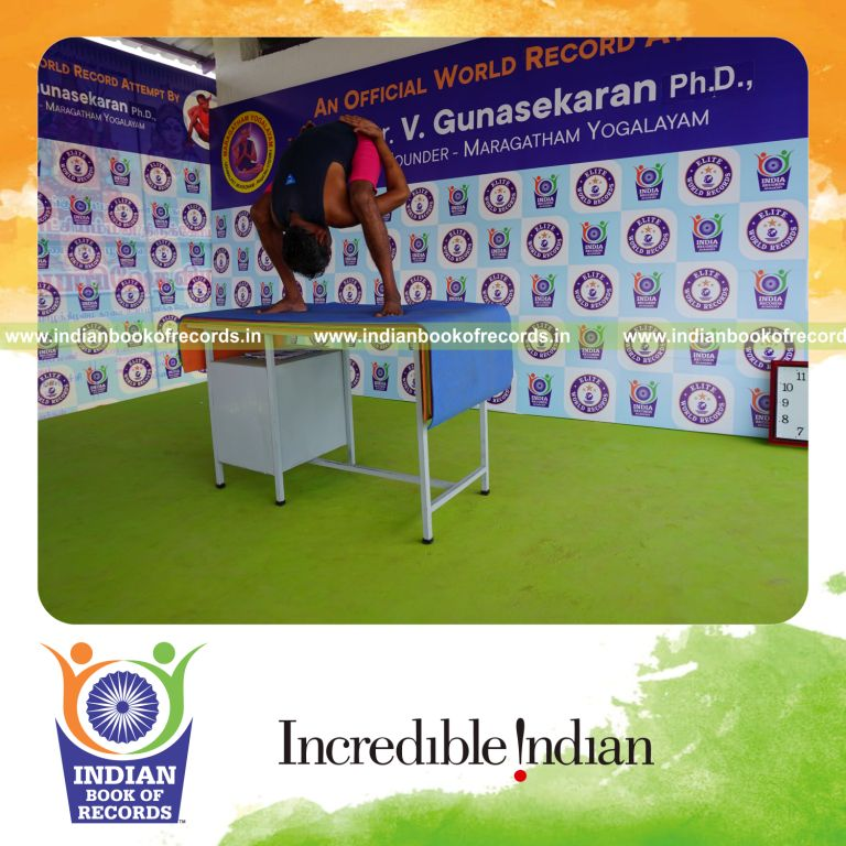 individual holding uthitha titibasana yoga pose on a table for record in Indian Book of Records