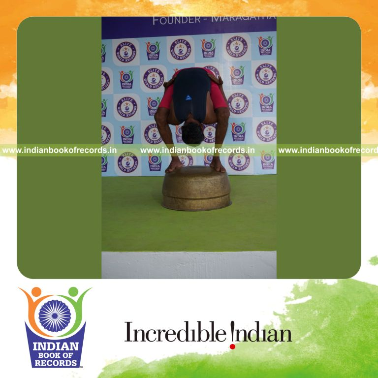 individual holding uthitha titibasana yoga pose on a vessel for record in Indian Book of Records