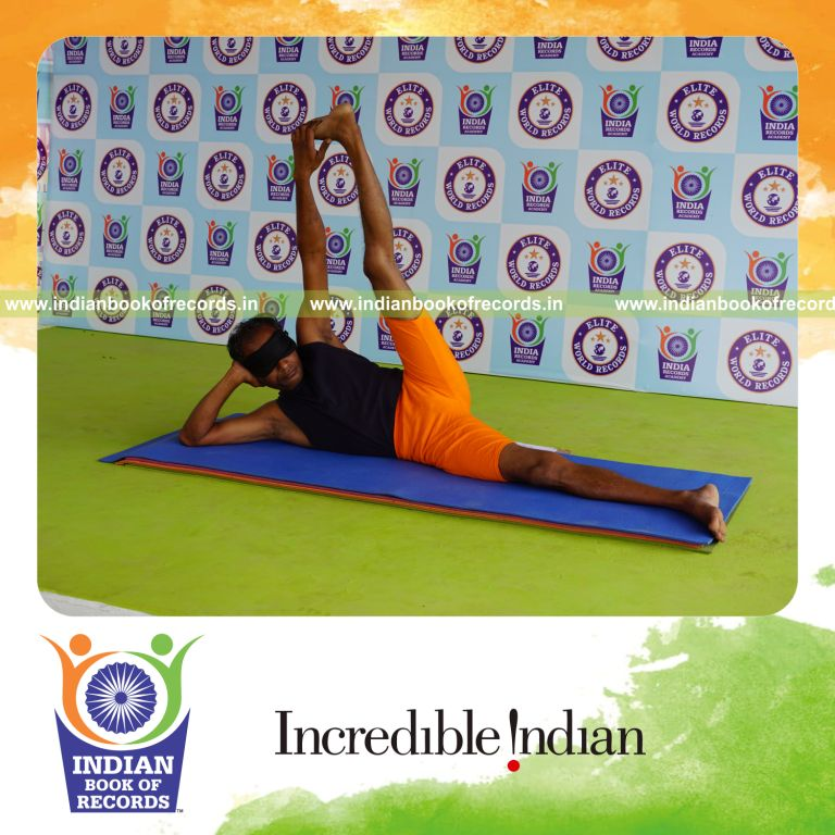individual holding vama anandasana yoga pose blindfolded for record in Indian Book of Records