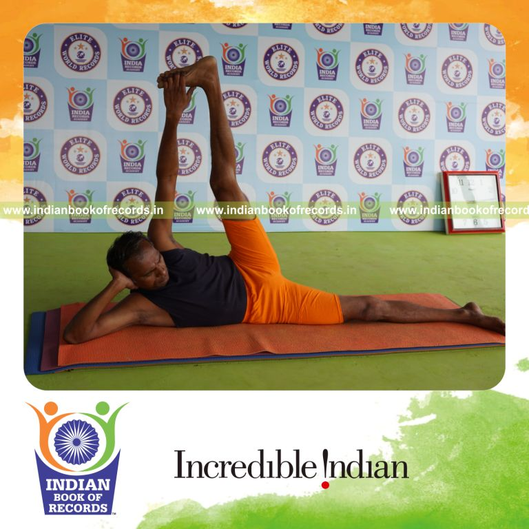 individual holding vama anandasana yoga pose for record in Indian Book of Records