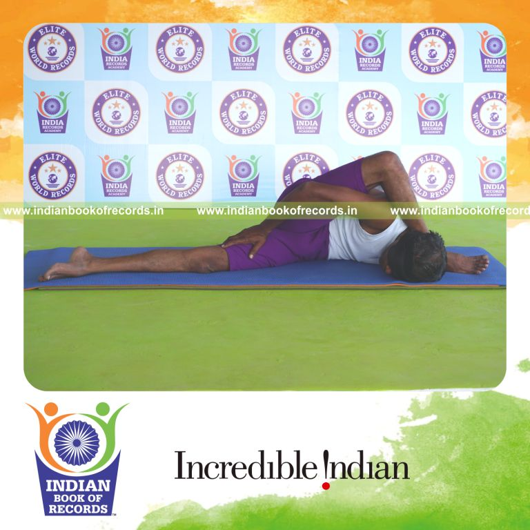 individual holding vama ardha astavakrasana yoga pose blindfolded for record in Indian Book of Records