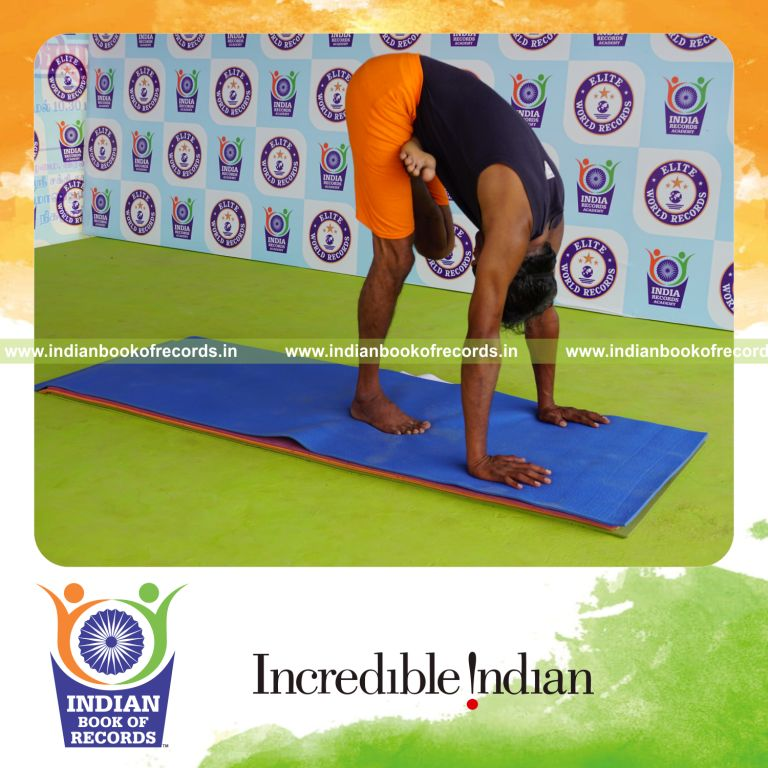 individual holding vama ardha baddha padmottasana yoga pose blindfolded for record in Indian Book of Records