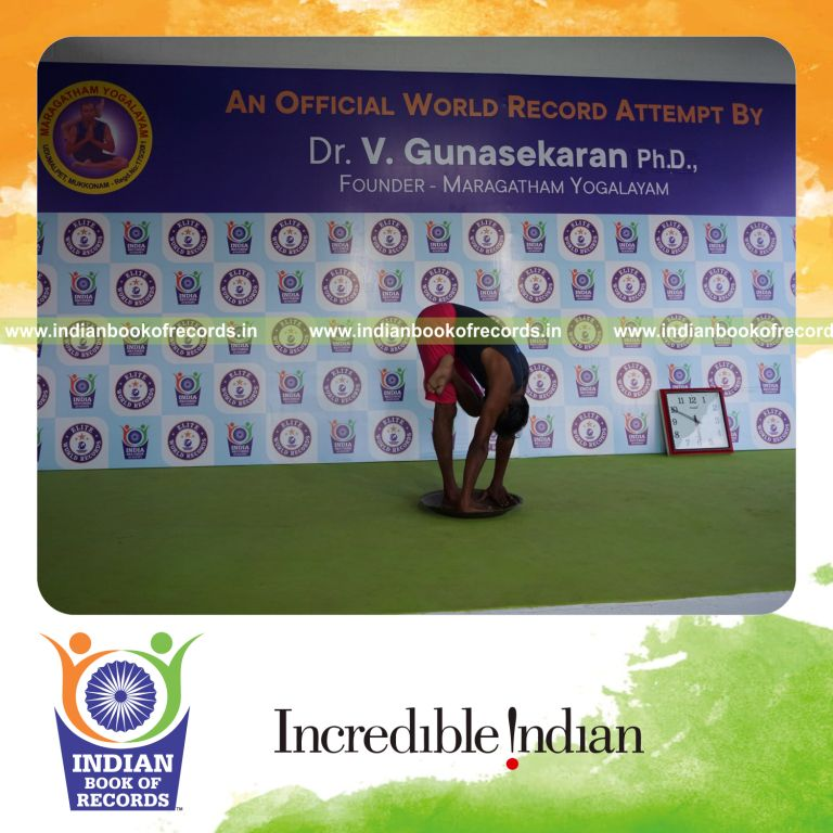 individual holding vama ardha baddha padmottasana yoga pose on a brass plate for record in Indian Book of Records