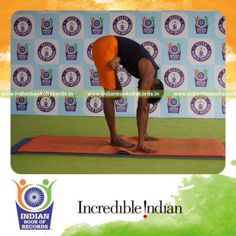 individual holding vama ardha baddha padmottasana yoga pose for record in Indian Book of Records