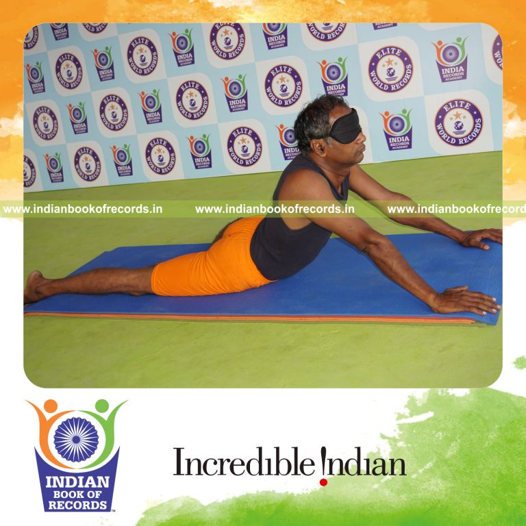 individual holding vama ardha bhujangasana yoga pose blindfolded for record in Indian Book of Records