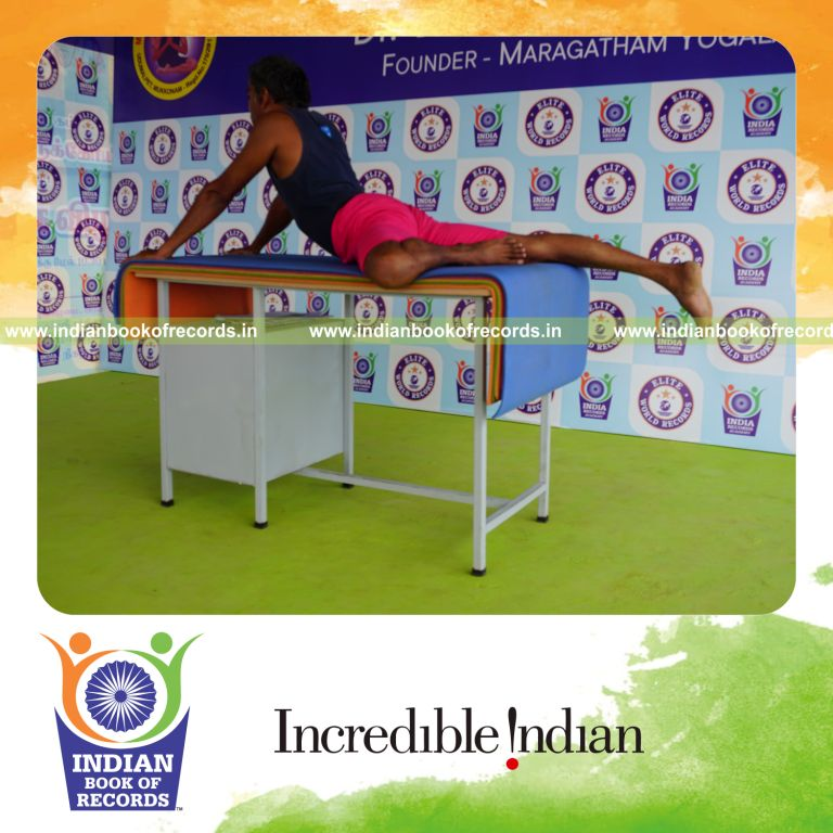 individual holding vama ardha bhujangasana yoga pose on a table for record in Indian Book of Records