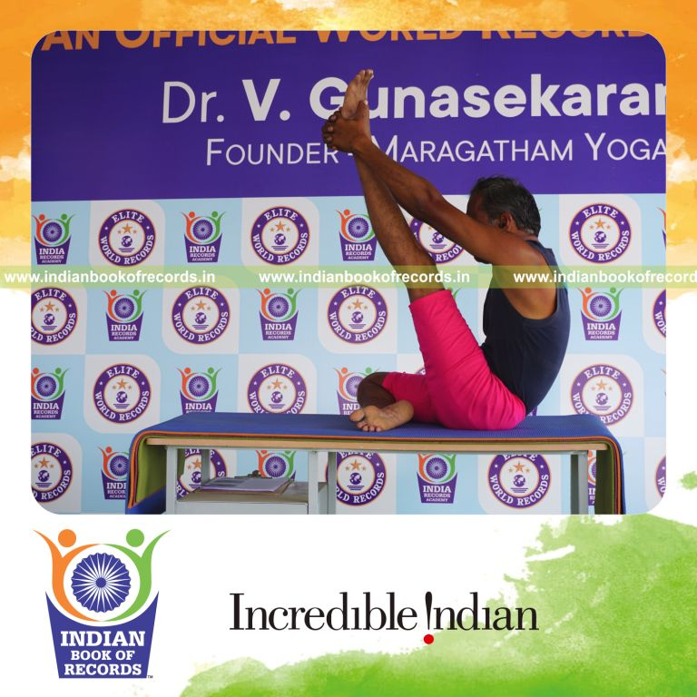 an individual holding vama ardha krounchasana yoga pose on a table for the longest duration with balance and flexibility for a record in Indian Book of Records
