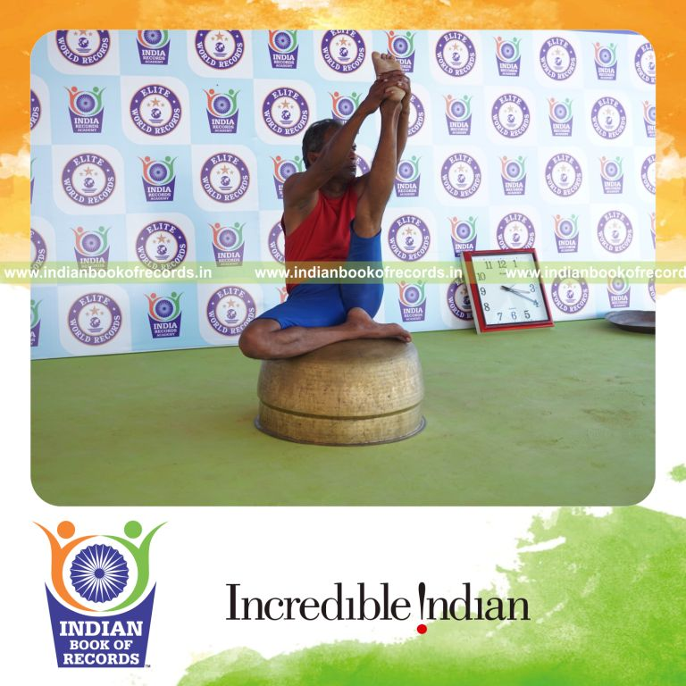 individual holding vama ardha krounchasana yoga pose on a vessel for record in Indian Book of Records