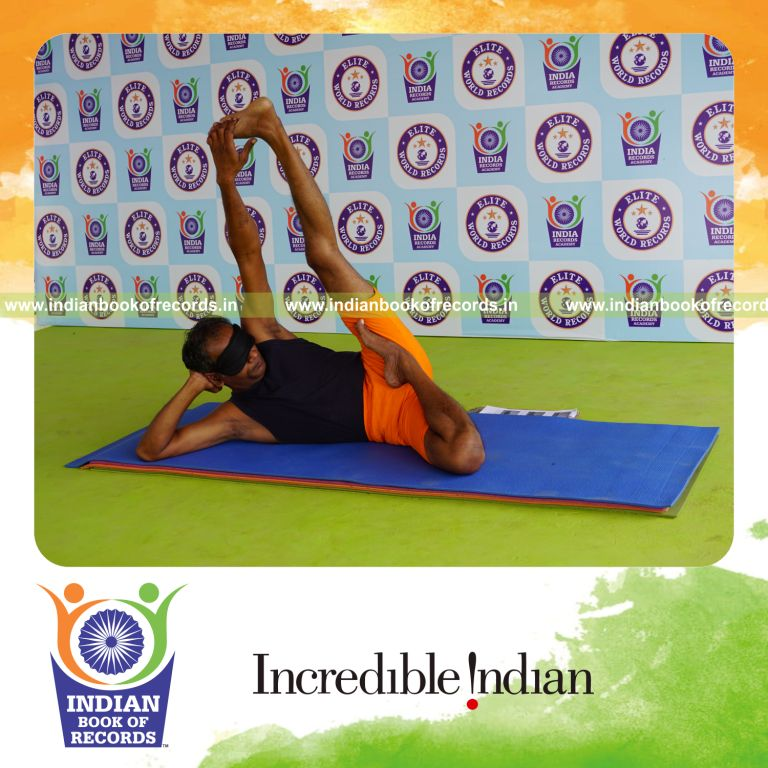 individual holding vama ardha padma anantasana yoga pose blindfolded for record in Indian Book of Records