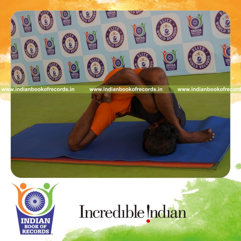 individual holding vama ardha padma astavakrasana yoga pose blindfolded for record in Indian Book of Records