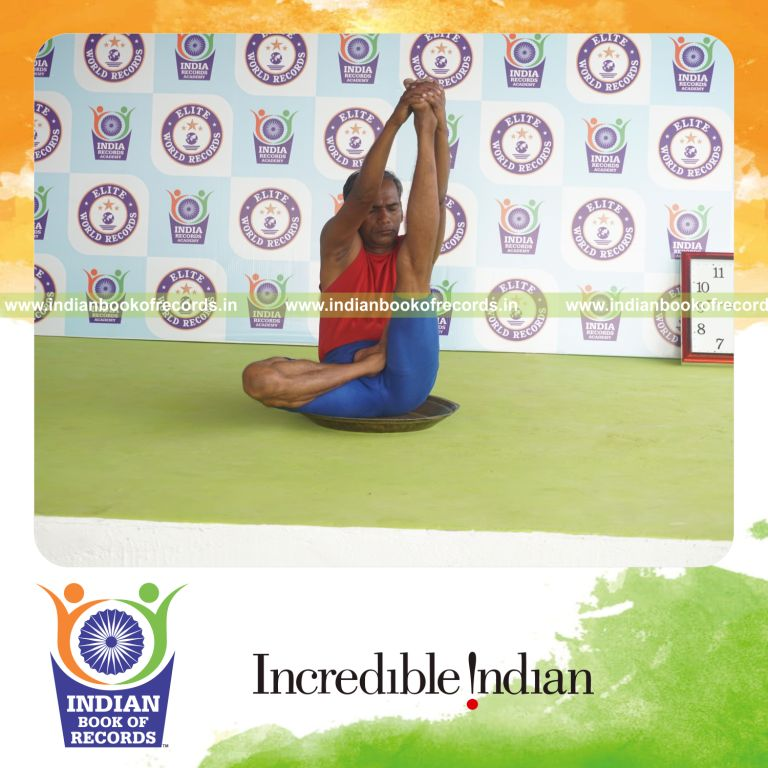 individual holding vama ardha padma krounchasana yoga pose on a brass plate for record in Indian Book of Records