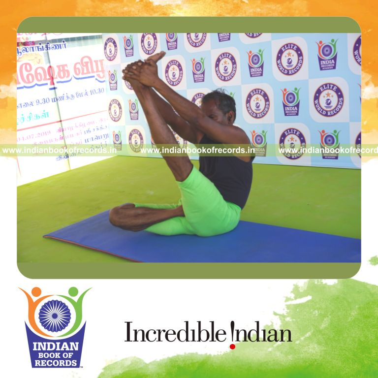 an individual holding vama ardha padma krounchasana yoga pose continuously for the longest duration with flexibility and control for a record in Indian Book of Records