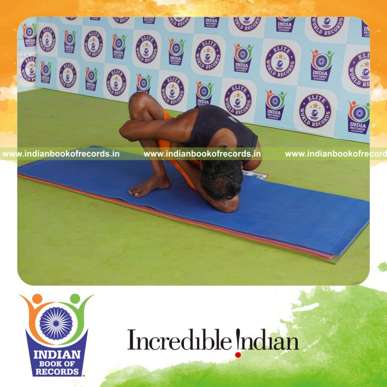 individual holding vama ardha padma marichyasana yoga pose for record in Indian Book of Records