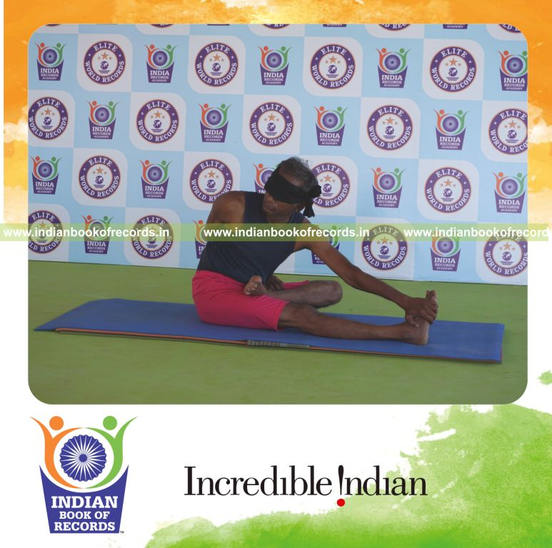 an individual holding vama ardha padma matsyendrasana yoga pose blindfolded for the longest duration with flexibility and balance for a record in Indian Book of Records