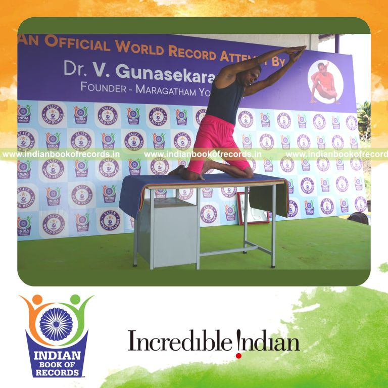 an individual holding vama ardha padma ustraa konasana yoga pose on a table for the longest duration with balance and control for a record in Indian Book of Records