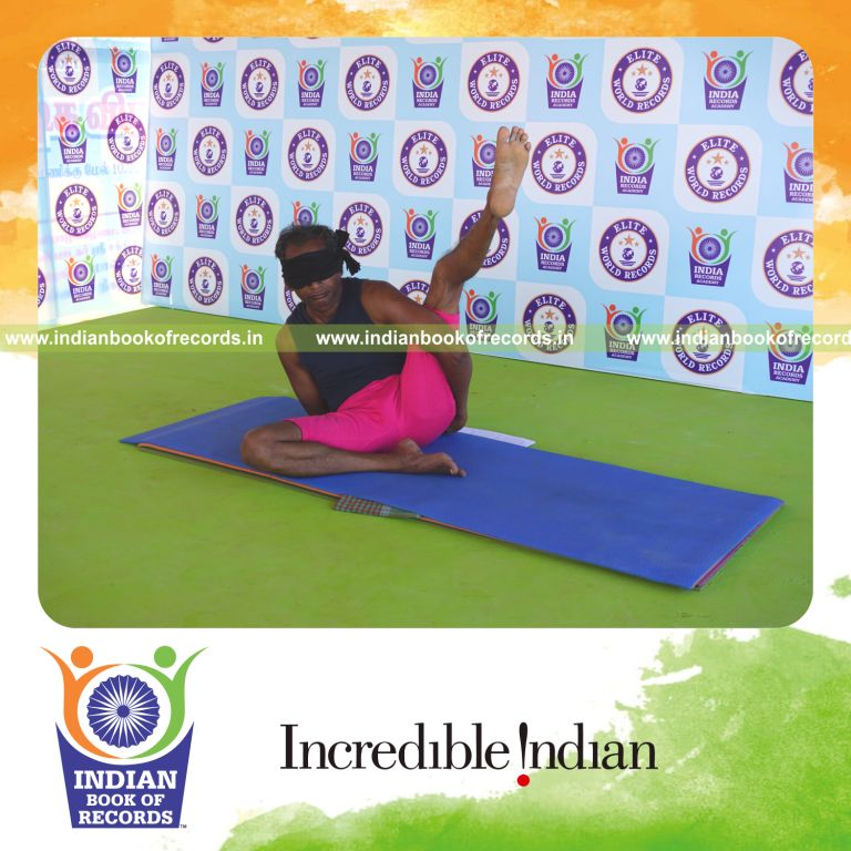an individual holding vama ardha parsva krounchasana yoga pose blindfolded for the longest duration with flexibility and balance for a record in Indian Book of Records