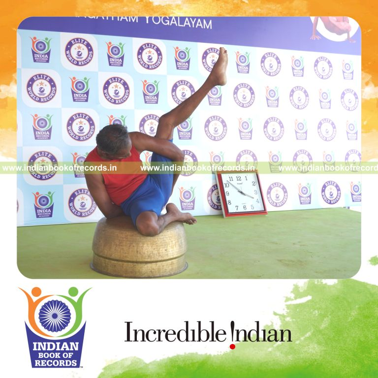 individual holding vama ardha parsva krounchasana yoga pose on a vessel for record in Indian Book of Records