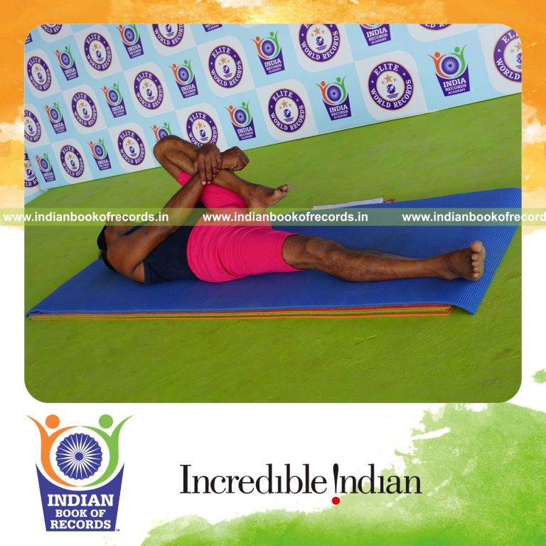 individual holding vama ardha pavanamuktasana yoga pose blindfolded for record in Indian Book of Records