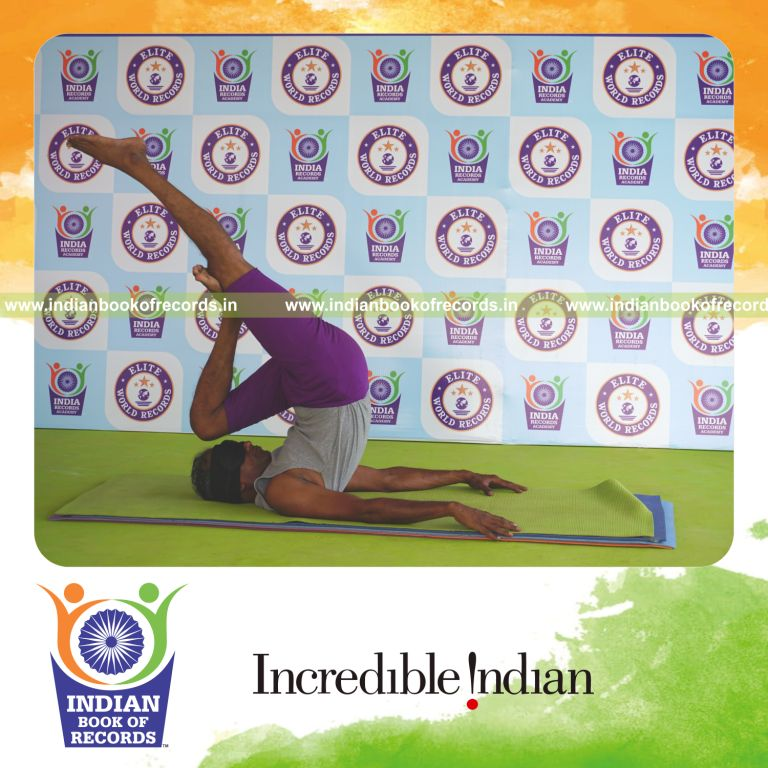 individual holding vama ardha salamba sarvangasana yoga pose blindfolded for record in Indian Book of Records