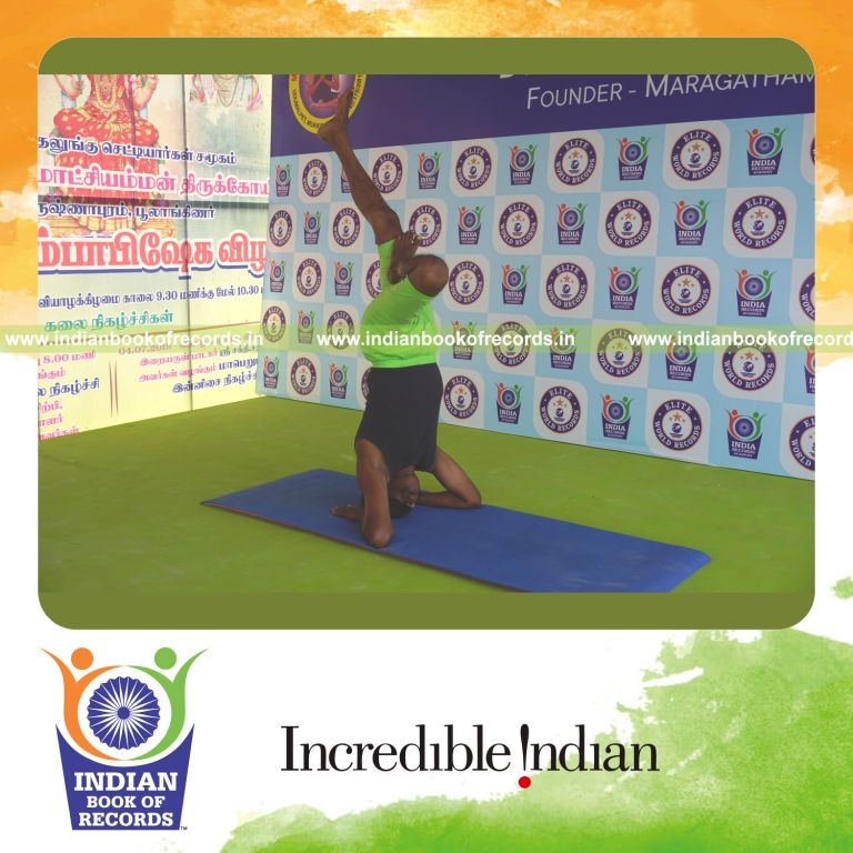 an individual holding vama ardha salamba sirsasana yoga pose blindfolded for the longest duration with stability and control for a record in Indian Book of Records