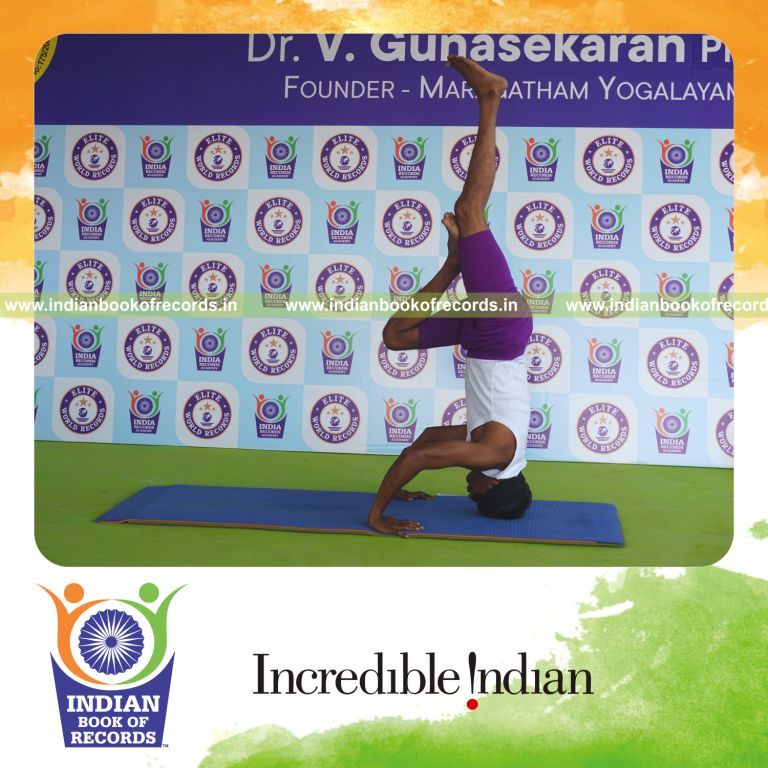 individual holding vama ardha salamba sirsasana second type yoga pose blindfolded for record in Indian Book of Records