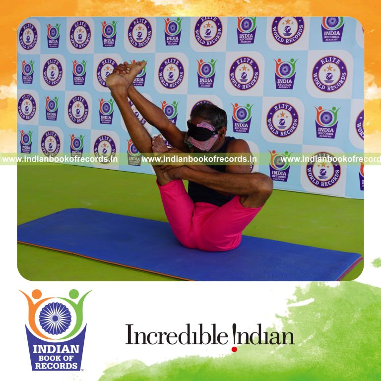 an individual holding vama ardha urdhva mukha paschimottanasana yoga pose blindfolded for the longest duration with flexibility and control for a record in Indian Book of Records