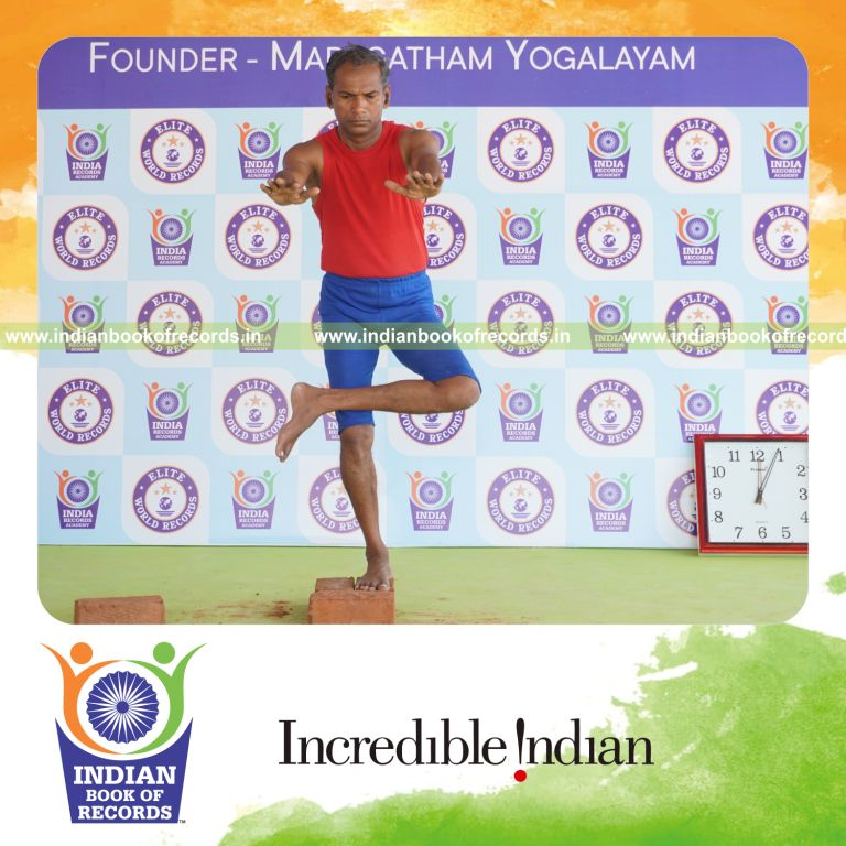 individual holding vama ardha utkatasana yoga pose on bricks for record in Indian Book of Records