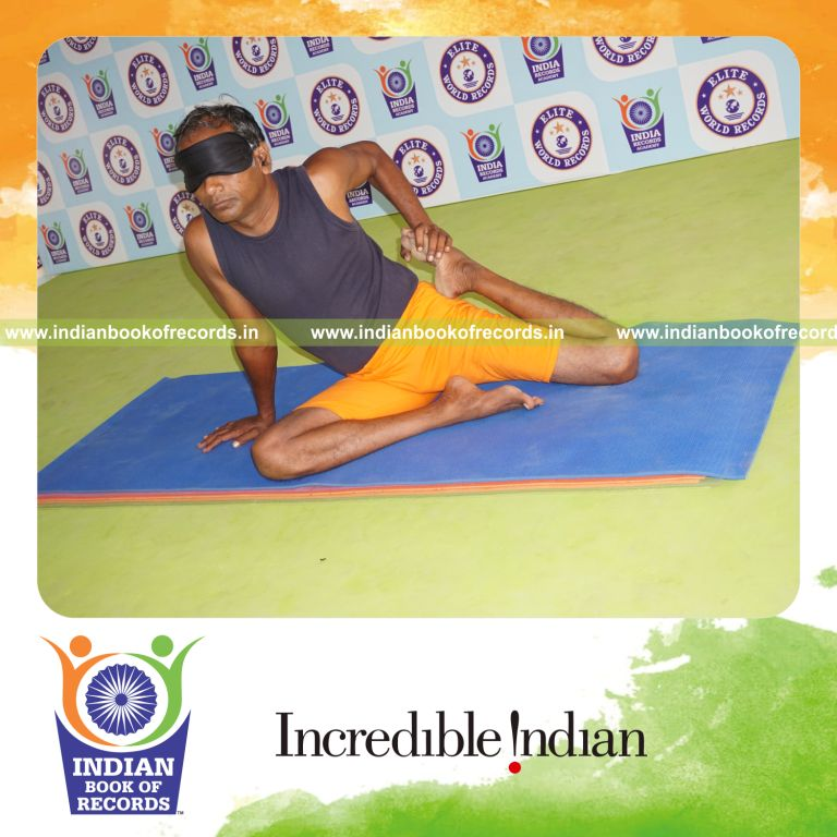 individual holding vama ardha vamadevasana yoga pose blindfolded for record in Indian Book of Records