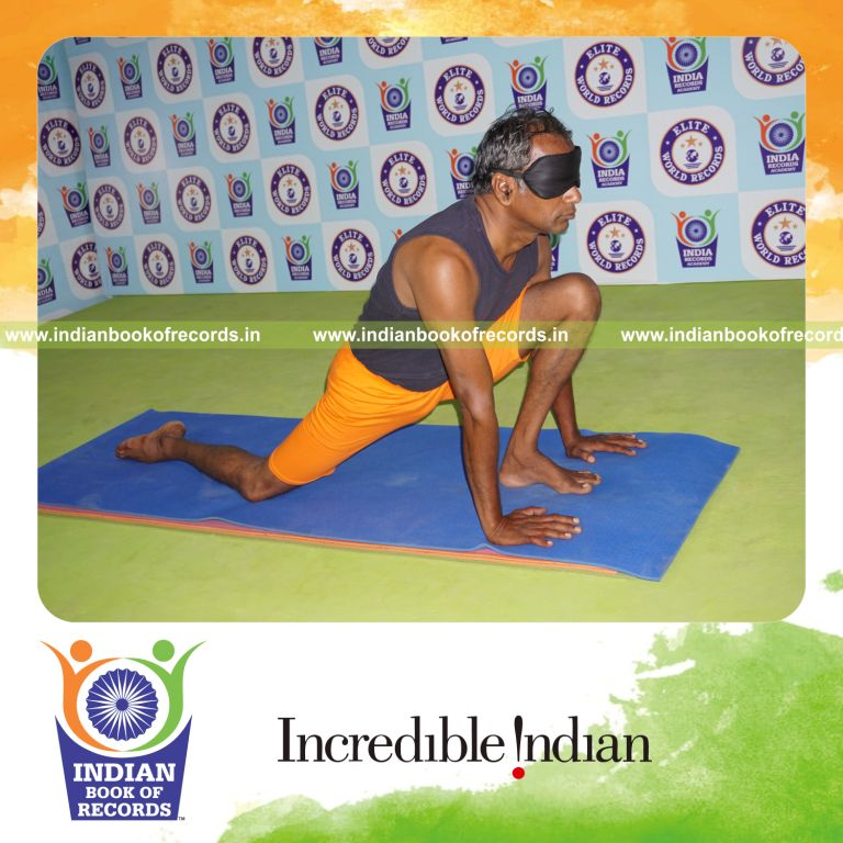 individual holding vama asva chanjalanasana yoga pose blindfolded for record in Indian Book of Records