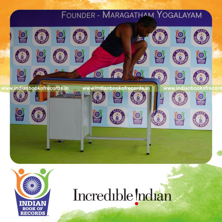 individual holding vama asva chanjalanasana yoga pose on a table for record in Indian Book of Records