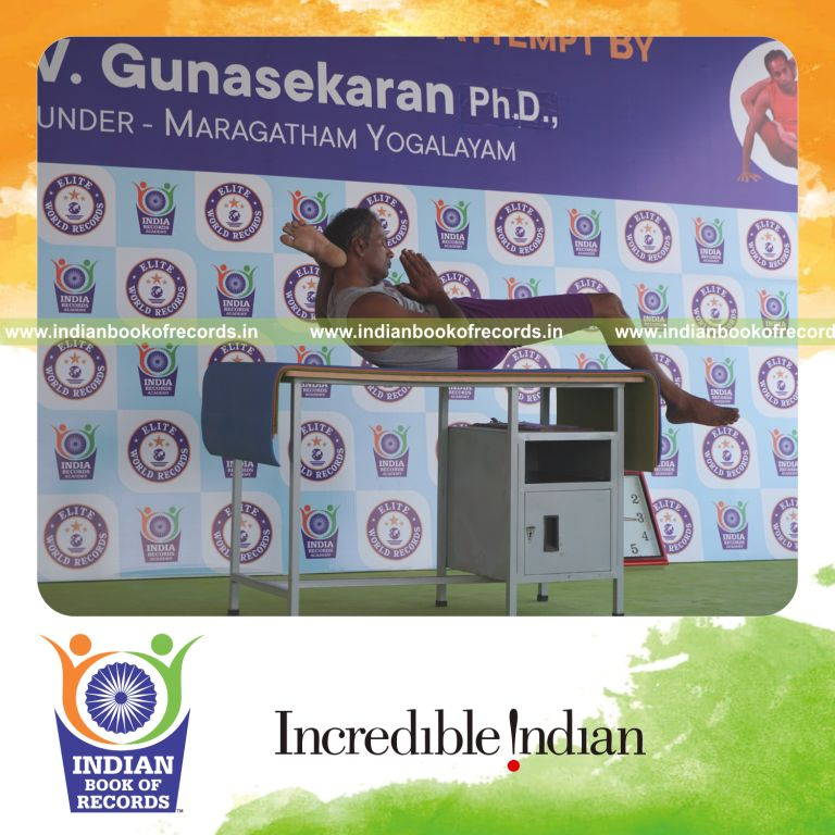 individual holding vama bhairavasana yoga pose on a table for record in Indian Book of Records