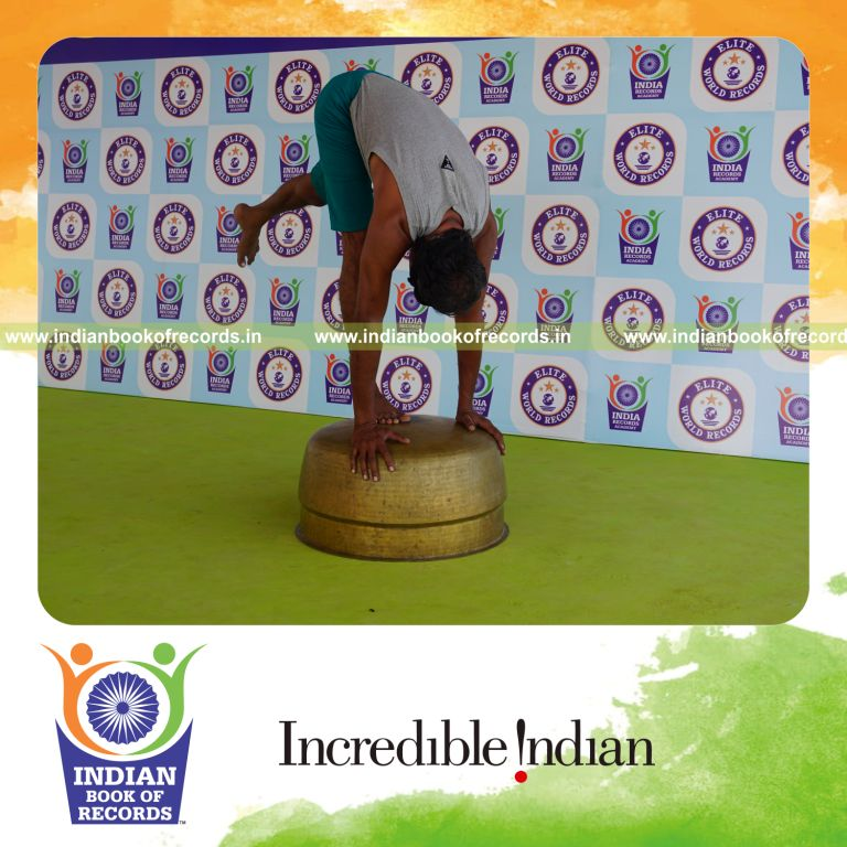 individual holding vama ekapada padahastasana yoga pose blindfolded on a vessel for record in Indian Book of Records