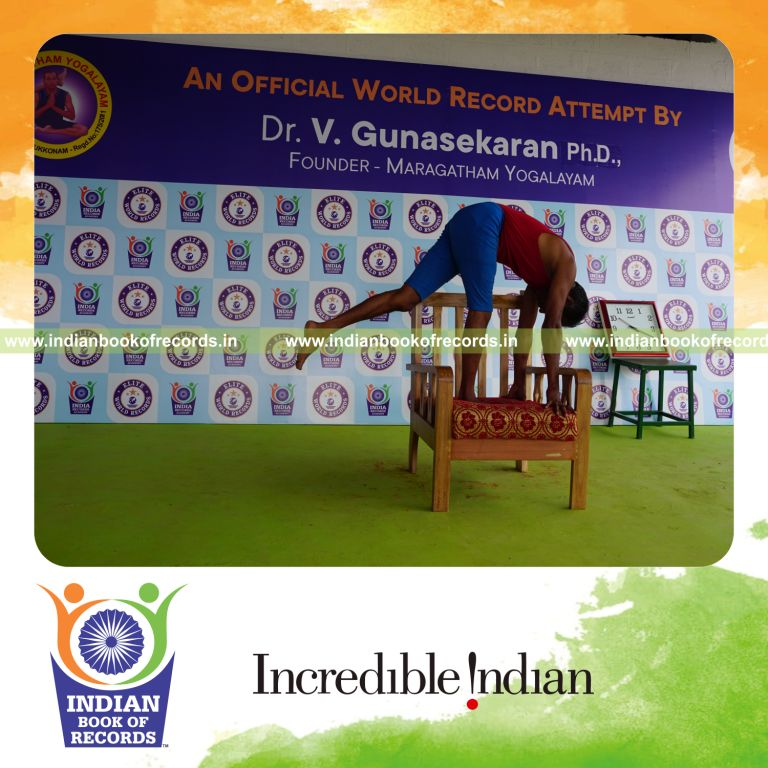 individual holding vama ekapada padahastasana yoga pose on a chair for record in Indian Book of Records