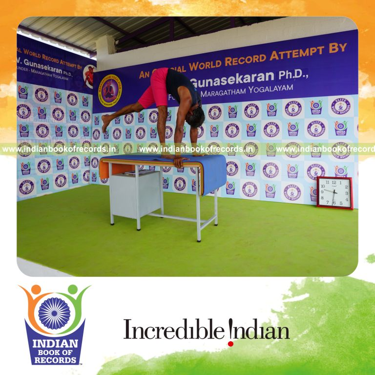 individual holding vama ekapada padahastasana yoga pose on a table for record in Indian Book of Records