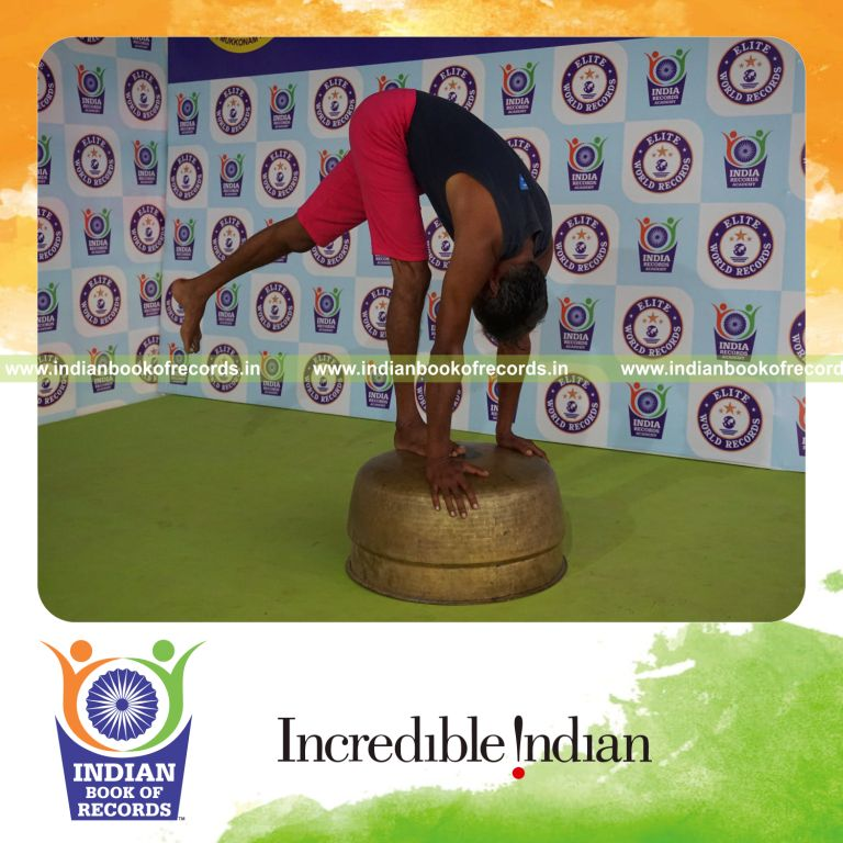 individual holding vama ekapada padahastasana yoga pose on a vessel for record in Indian Book of Records