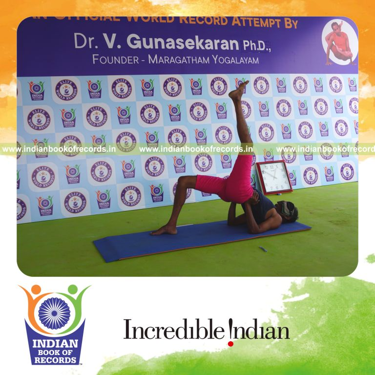 an individual holding vama ekapada setu bandha sarvangasana yoga pose blindfolded for the longest duration with control and balance for a record in Indian Book of Records