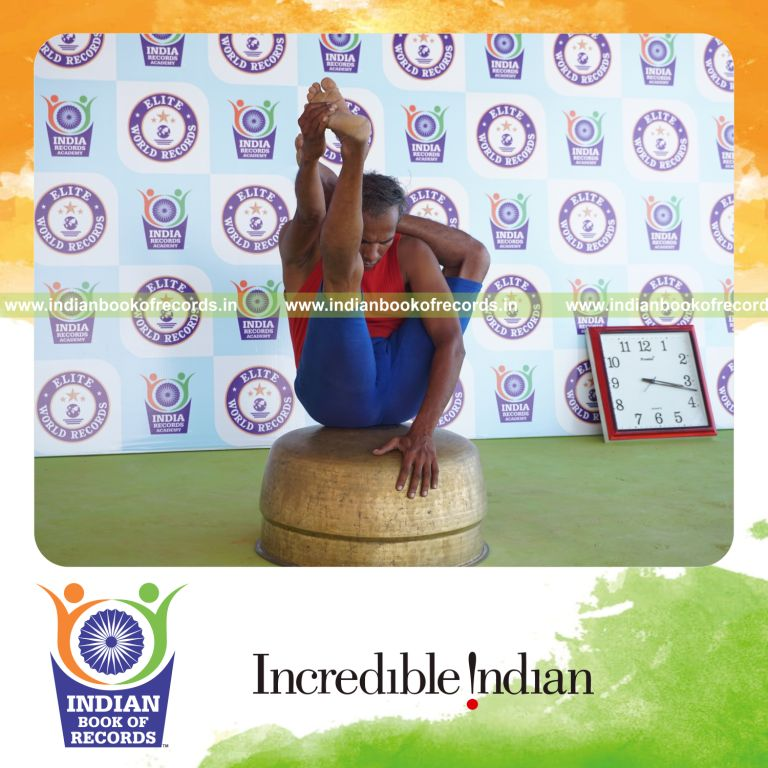 individual holding vama ekapada sirasa krounchasana yoga pose on a vessel for record in Indian Book of Records