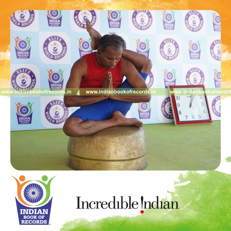 individual holding vama ekapada sirsasana yoga pose on a vessel for record in Indian Book of Records