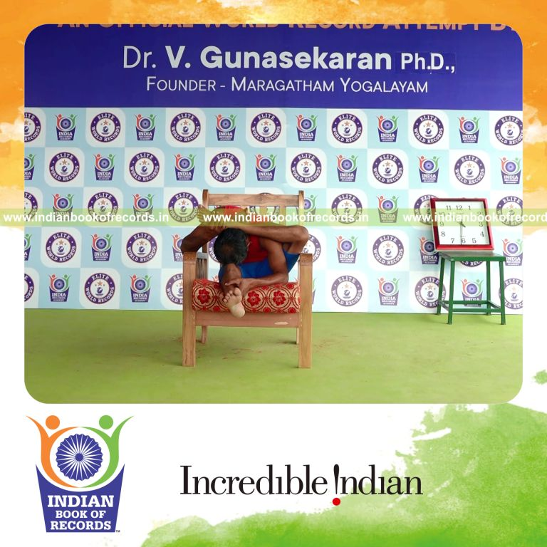 individual holding vama ekapada skandasana yoga pose on a chair for record in Indian Book of Records