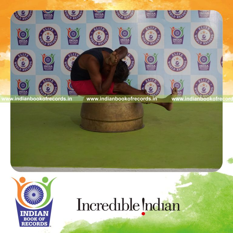 individual holding vama ekapada skandasana yoga pose on a vessel for record in Indian Book of Records