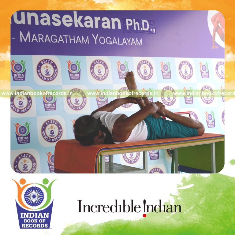 individual holding vama gherandasana first type yoga pose blindfolded on a table for record in Indian Book of Records