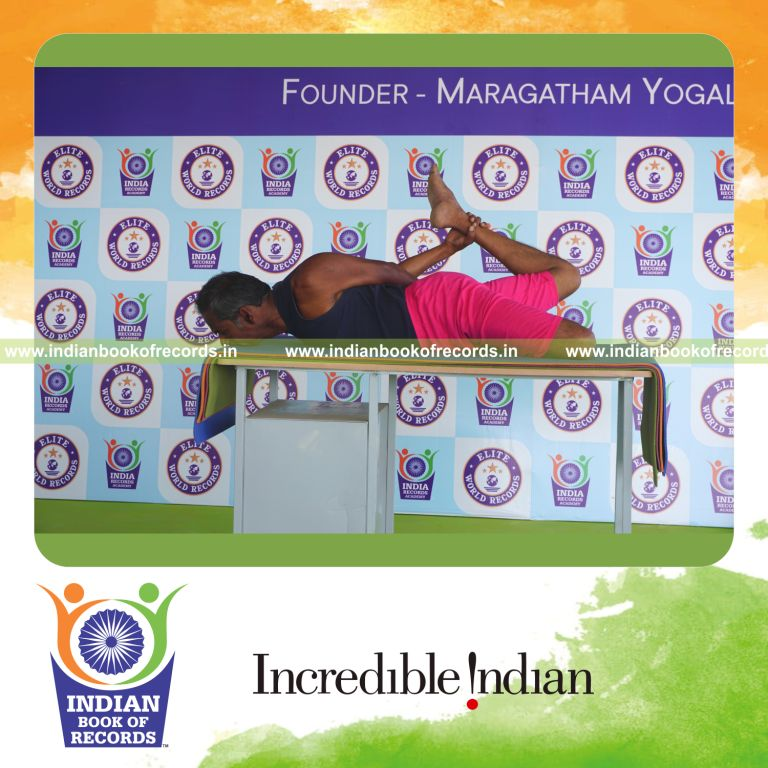 an individual holding vama gherandasana second type yoga pose on a table for the longest duration with balance and control for a record in Indian Book of Records