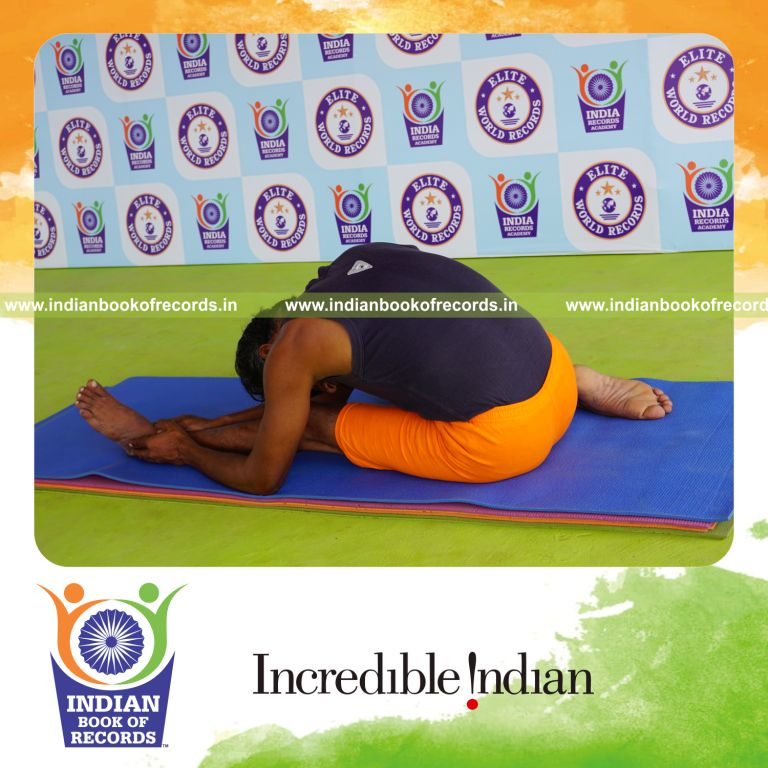 individual holding vama gomukha janu sirsasana yoga pose blindfolded for record in Indian Book of Records