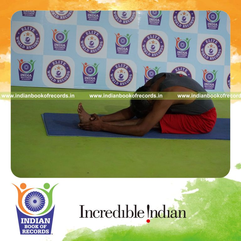 individual holding vama gomukha janu sirsasana yoga pose for record in Indian Book of Records