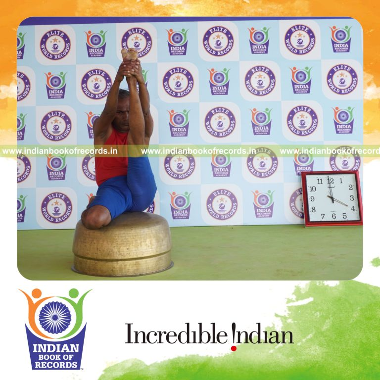 individual holding vama gomukha krounchasana yoga pose on a vessel for record in Indian Book of Records
