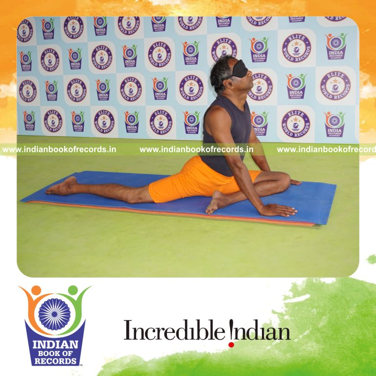 individual holding vama janu bhujangasana yoga pose blindfolded for record in Indian Book of Records
