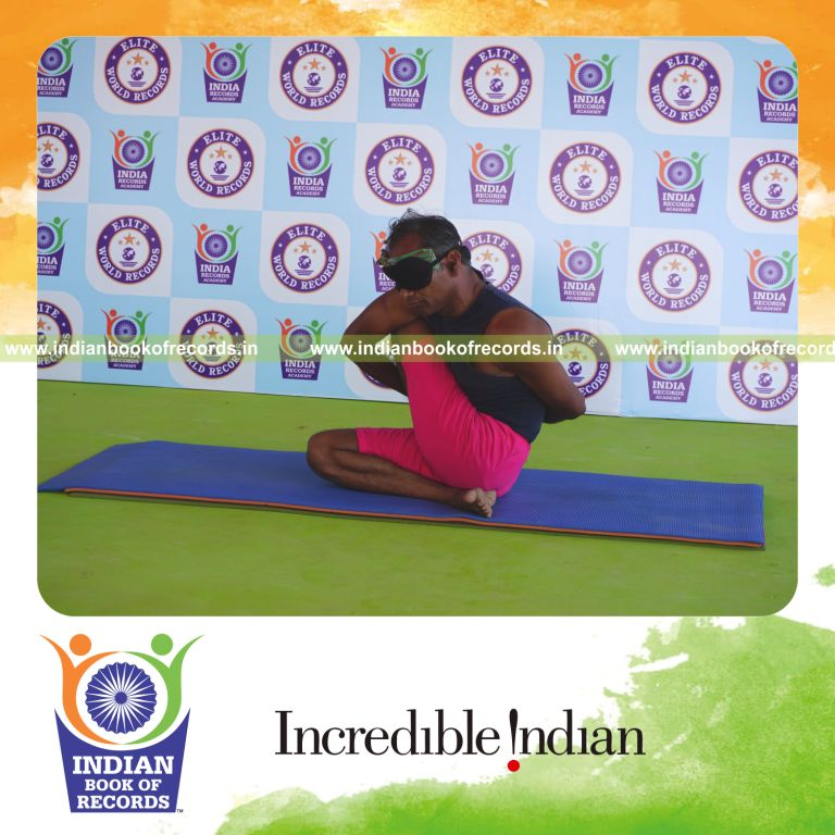 an individual holding vama janu parivrtta ardha matsyendrasana yoga pose blindfolded for the longest duration with flexibility and balance for a record in Indian Book of Records