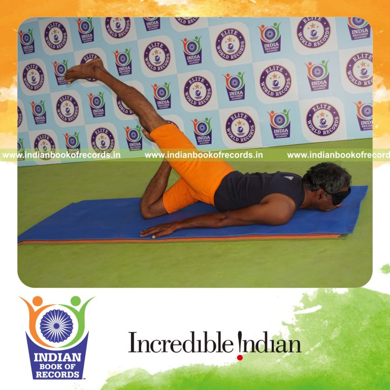individual holding vama janu salabhasana yoga pose blindfolded for record in Indian Book of Records