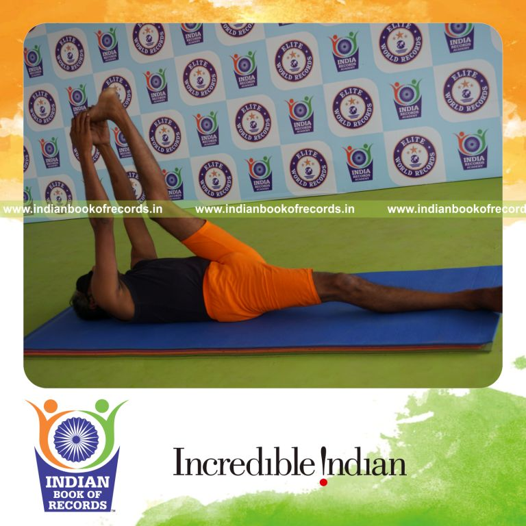 individual holding vama julasana yoga pose blindfolded for record in Indian Book of Records